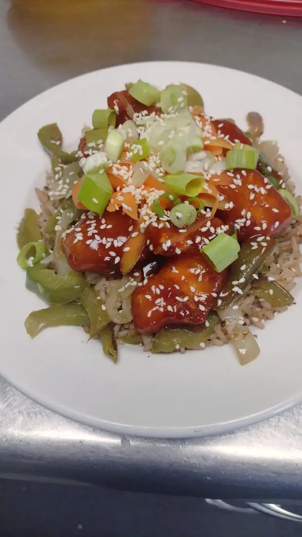Poulet Général Tao maison sur riz aux légumes, oignons verts et sésame